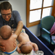 Sears examines 2-mo-old twins Andrew and William Sandoval in his Capistrano Beach, CA, pediatrics office on Aug 8, 2014. as their mother Karissa Sandoval looks on. Neither child pictured here is the patient discussed in the complaint against Sears. Photo via Getty